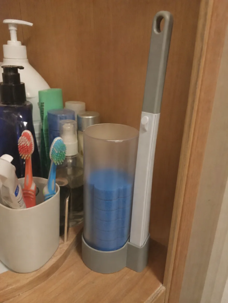 TossClean caddy and wand on a bathroom shelf